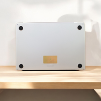 Laptop on a wooden surface with a blurred background