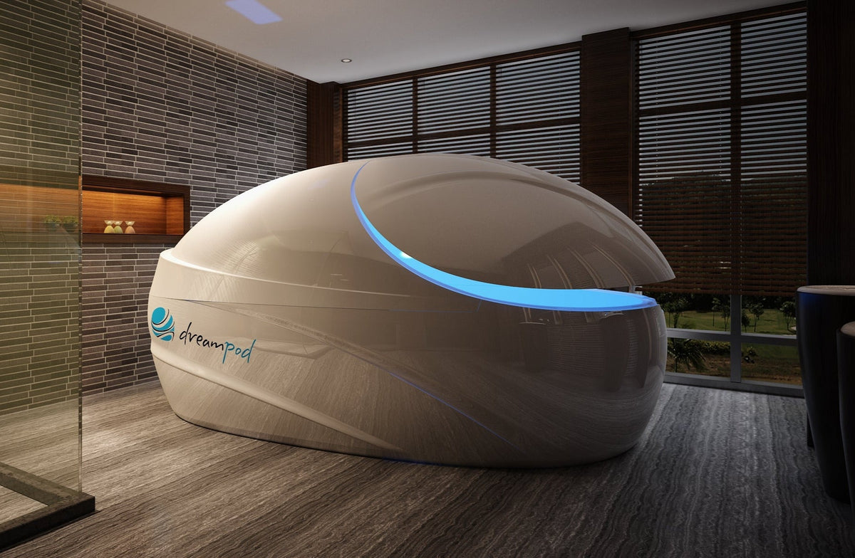 White pod with blue light inside a room, branded 'dreampod'.