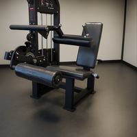 Gym machine with black padding and metal frame on a gray floor.
