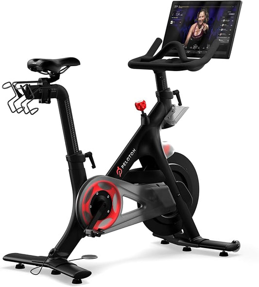 Peloton stationary bike with digital display on a white background