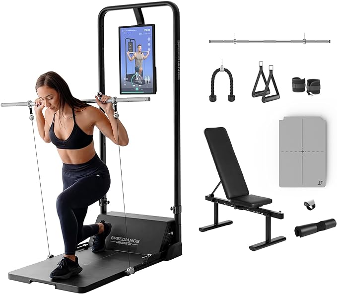 Home gym setup with exercise equipment including a screen, bench, and various attachments.