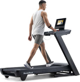 Man using a NordicTrack treadmill on a white background