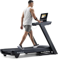 Man using a NordicTrack treadmill on a white background