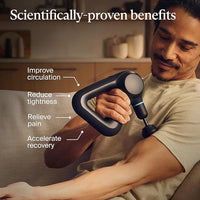 Man using a handheld massage device on his arm with text highlighting benefits in a kitchen setting
