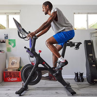 Man exercising on a stationary bike in a home setting