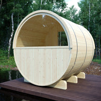 Wooden barrel-shaped structure on a wooden platform with trees in the background