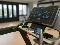 Treadmill control panel with digital display in a gym setting
