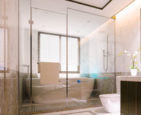 Modern bathroom with glass shower enclosure, bathtub, and toilet.