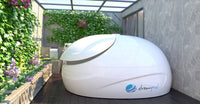 White pod with 'dreampod' logo on a patio with greenery