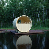 Wooden circular structure on a platform over water with trees in the background