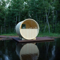Wooden circular structure on a platform over water with trees in the background