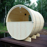 Wooden barrel-shaped structure on a wooden platform with trees in the background