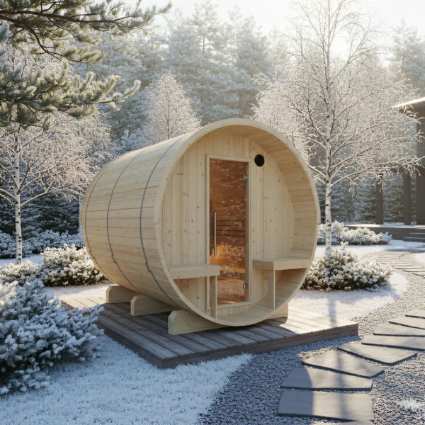 Wooden barrel-shaped sauna in a snowy outdoor setting with trees and pathways.