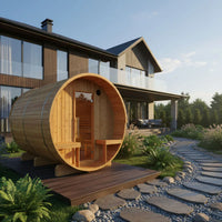 Wooden barrel sauna in front of a modern house with a clear sky.