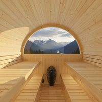 Wooden sauna with a large circular window showing mountain scenery