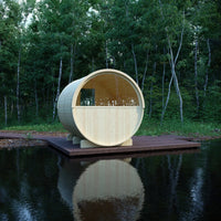 Wooden circular structure on a platform over water with trees in the background