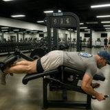 Man exercising on a leg press machine in a gym setting