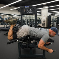 Man using a leg extension machine in a gym setting