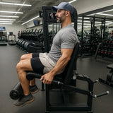Man exercising on a machine in a gym setting