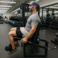 Man exercising on a machine in a gym setting