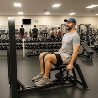 Man exercising on a leg press machine in a gym
