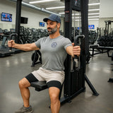 Man exercising on a machine in a gym setting
