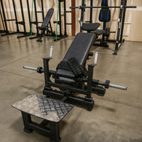 Black weight bench with weight attachments in a gym setting